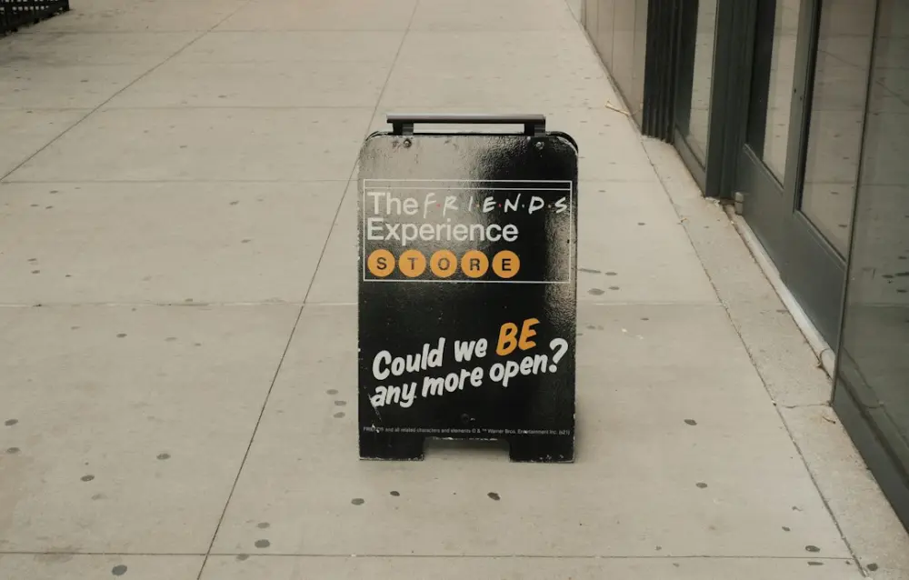 The friends experience sign on a city sidewalk, illustrating conversion experience